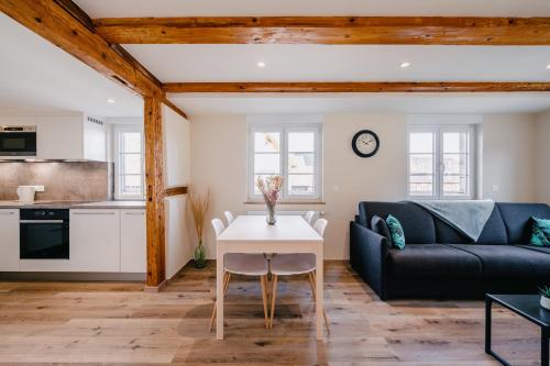 a living room with a couch and a table at Résidence Les Charmes in Boofzheim