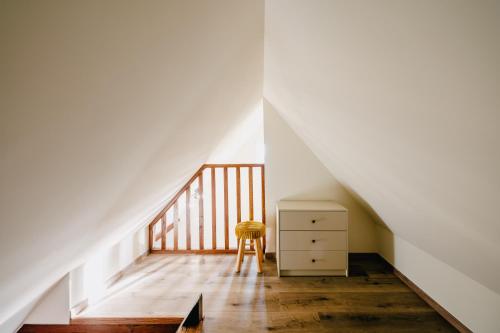 a staircase with a chair and a dresser in a room at Résidence Les Charmes in Boofzheim