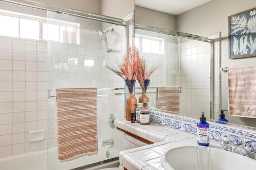 a bathroom with a tub and a sink and a mirror at Escondido Home Private Pool, 2 Grills and Fire Pit! in Escondido