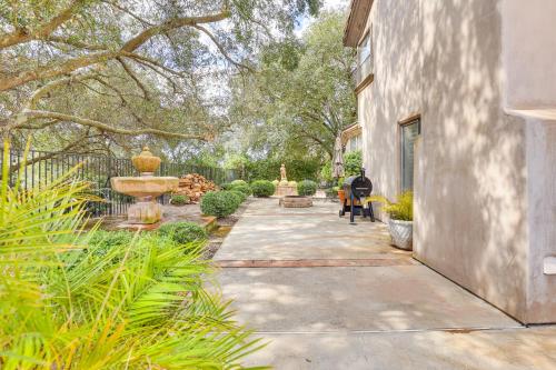 a person sitting on a bench in a garden at Escondido Home Private Pool, 2 Grills and Fire Pit! in Escondido