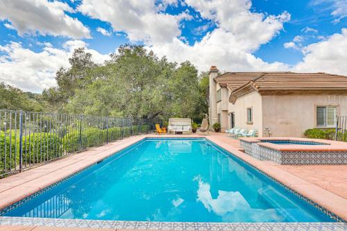 a swimming pool in the backyard of a house at Escondido Home Private Pool, 2 Grills and Fire Pit! in Escondido