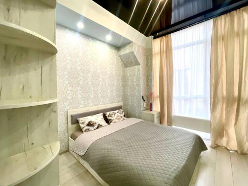 a small bedroom with a bed and a window at NewStyle in Kharkiv
