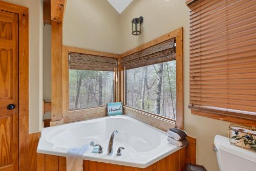a bathroom with a tub and a window at Shady Maples Lodge in Townsend