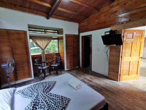 a bedroom with a bed and a television and a table at Ecogreen Hotel - San Cipriano in San Cipriano