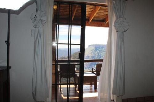 Cette chambre offre une vue sur une chambre dotée de fenêtres. dans l'établissement Hotel Divisadero Barrancas, à El Divisadero