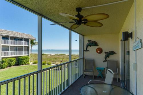a balcony with a ceiling fan and a view of the ocean at Sanibel Siesta on the Beach unit 501 condo in Sanibel