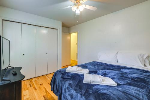 a bedroom with a blue bed with a ceiling fan at Pet-Friendly Roanoke Home with Fire Pit and Grill! in Roanoke