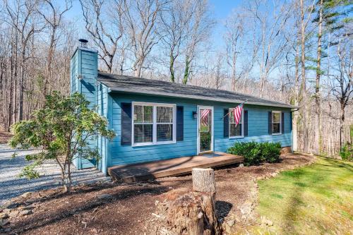 a blue tiny house with a wooden porch at Pet-Friendly Roanoke Home with Fire Pit and Grill! in Roanoke