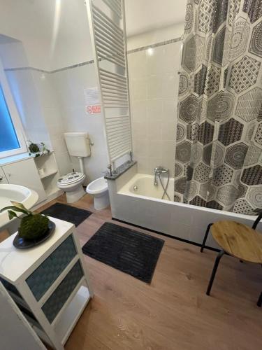 a bathroom with a tub and a toilet and a shower at A D R Holiday Home in Casale Corte Cerro