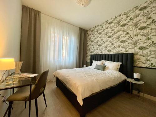 a bedroom with a bed and a table and a chair at Aglaya 3 - Luxury 2BR Apartment in Belgrade