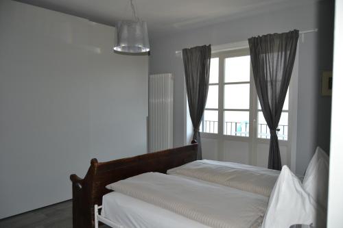a bedroom with two beds and a window at Solivonatural Apartment in Cannobio
