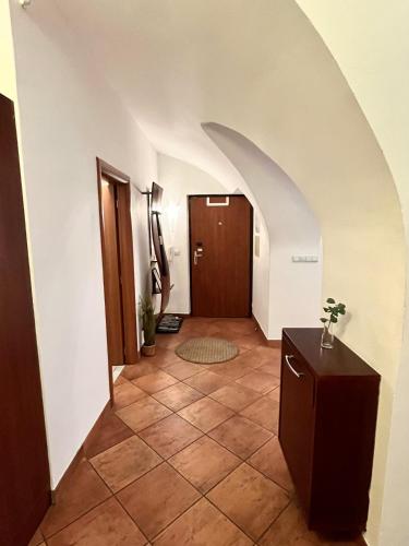 a hallway with a door and a tile floor at Apartment Sophie - Old Town in Bratislava