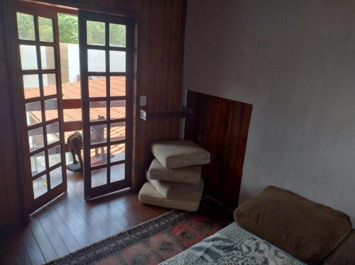 a bedroom with a bed and a stairway with a door at CASA TO Patrao LUXO in Itapecerica da Serra