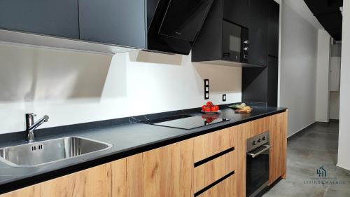 a kitchen with a sink and a counter top at Living4malaga Victoria Center Apartment in Málaga