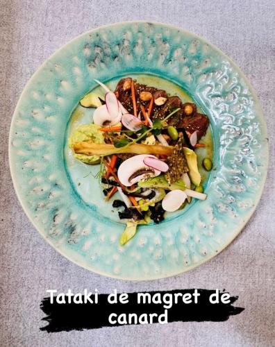 a plate of food with a salad on it at Hotel L'Océan in Le Bois-Plage-en-Ré