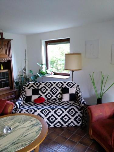 a living room with a couch and a table at Tannhäuser Ferienwohnung in Bad Dürrheim