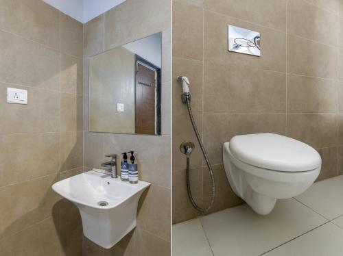 a bathroom with a toilet and a sink at Smart Stay by Luxe Gachibowli in Hyderabad
