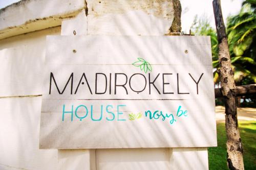 a sign for a maldridge house at MADIROKELY HOUSE Nosy Be in Ambatoloaka