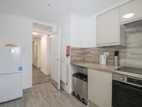 a kitchen with white cabinets and a counter top at Flat 32 - Marine Court in Littlehampton