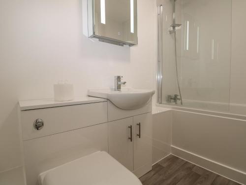 a white bathroom with a sink and a toilet at Flat 32 - Marine Court in Littlehampton