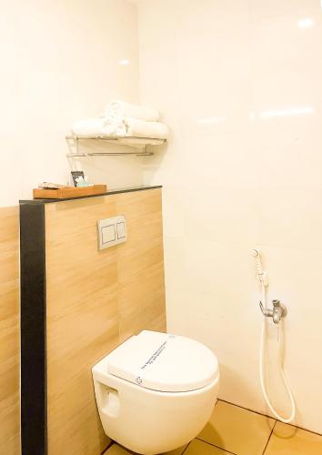 a bathroom with a toilet and a shower at Shree Residency in Erode