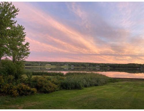 a view of a lake with a rainbow in the sky at The Bird in Hand in Egerton