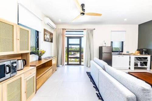 a living room with a couch and a kitchen at Onyx I Long Bay Retreat I Luxury Stay Near Grace Bay & Long Bay Beach in Long Bay Hills