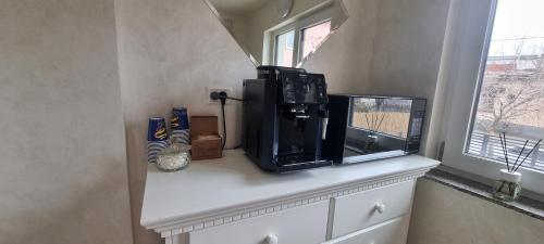 a microwave sitting on a counter next to a window at DNT HOUSE 2 in Craiova