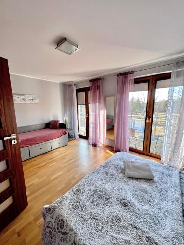 a bedroom with a bed and a large window at Apartamenty Ku Słońcu - Klifowa Jastrzębia Góra in Jastrzębia Góra