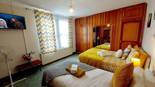 a hotel room with two beds and a window at Rose Villa- Great For Long & Short Stays!!! in Gillingham
