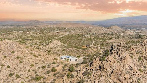 an aerial view of a house on a rocky mountain at Boulder Surrounded Escape- ANOTHERdeserthouse in Yucca Valley