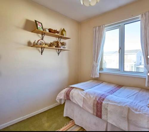 a bedroom with a bed and a window at Lilas Bangor NI in Bangor