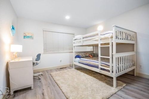 a bedroom with two bunk beds and a desk at Large Monterey Bay House close to Aquarium, Golf in Seaside