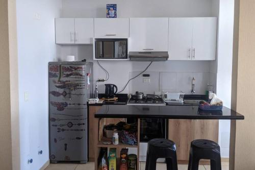 a kitchen with a counter and a refrigerator at Apartamento en Piura - Perú in Piura