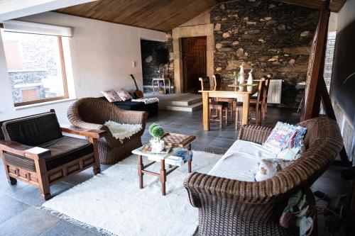 a living room with two chairs and a table at Casa da Ferreira_Vila Real in Vila Real
