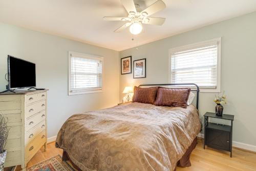 a bedroom with a bed and a flat screen tv at Pet-Friendly Alexandria Escape with Yard 8 Mi to DC in Alexandria