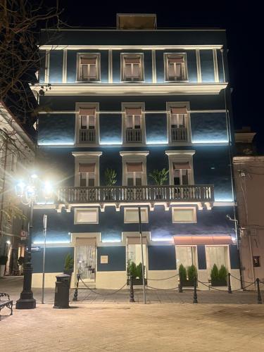 a black and white building with a balcony at night at WALLURE - Tickled Hotel & Wellness in Olbia