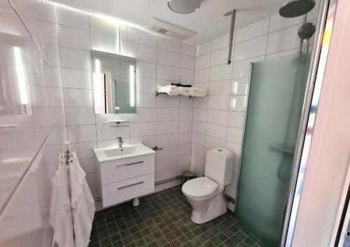 a bathroom with a toilet and a sink and a shower at GEG Hotel in Landskrona