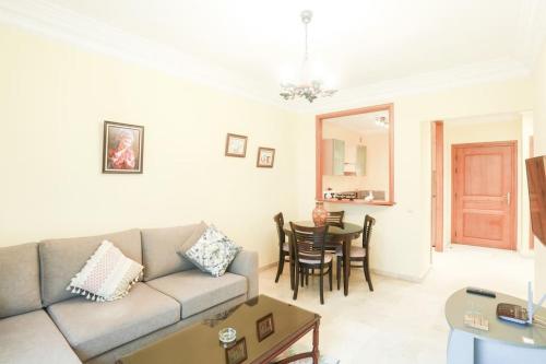 a living room with a couch and a table at Résidence Palace - Racine in Casablanca