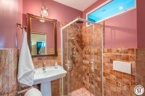 a bathroom with a sink and a shower at Domaine du Chateau Vert in Hondainville