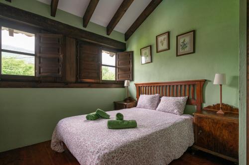 a bedroom with a bed with a stuffed animal on it at L´Agüera de Soberron in Llanes
