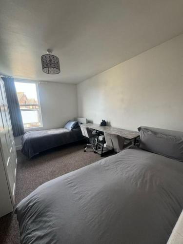 a bedroom with a bed and a desk and a couch at Comfy entire place for max 4. in London