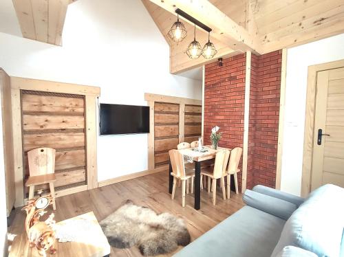 a living room with a blue couch and a table at Apartamenty Przy Rynku Szaflary in Szaflary