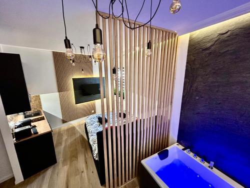 a bathroom with a blue tub and a sink at Ocean Black jacuzzi in Kraków