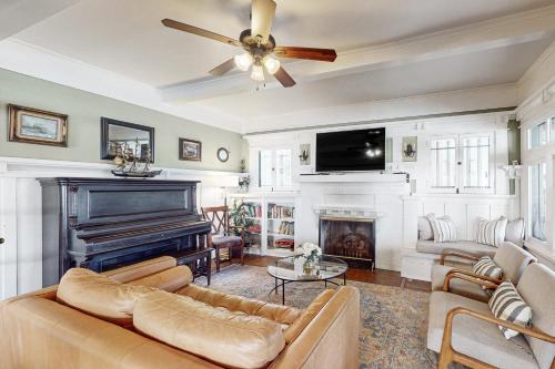 a living room with a couch and a piano at Old Yacht Club Inn in Santa Barbara