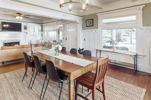 a dining room with a wooden table and chairs at Old Yacht Club Inn in Santa Barbara