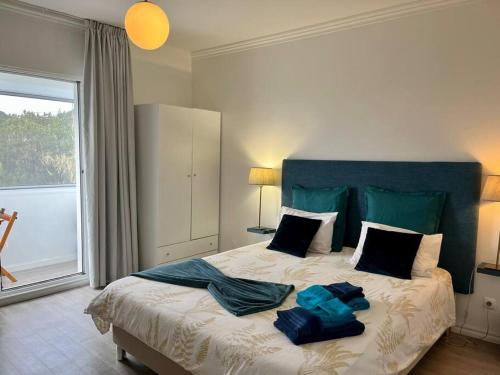 a bedroom with a large bed with towels on it at Caloura Water Accommodation in Lagoa