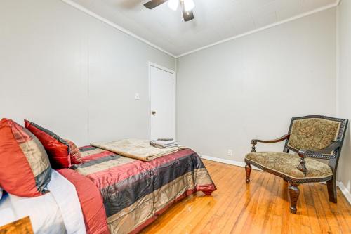 a bedroom with a bed and a chair at 6 Mi to Dtwn Attractions Buffalo Apartment! in Buffalo