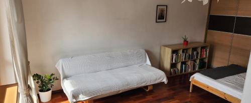 a living room with a couch and a book shelf at Nature in Kraków