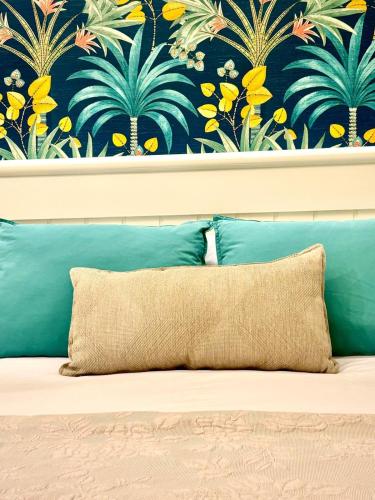 a couch with a pillow in front of a wall at El Patio de los Jazmines Boutique-House in Consuegra